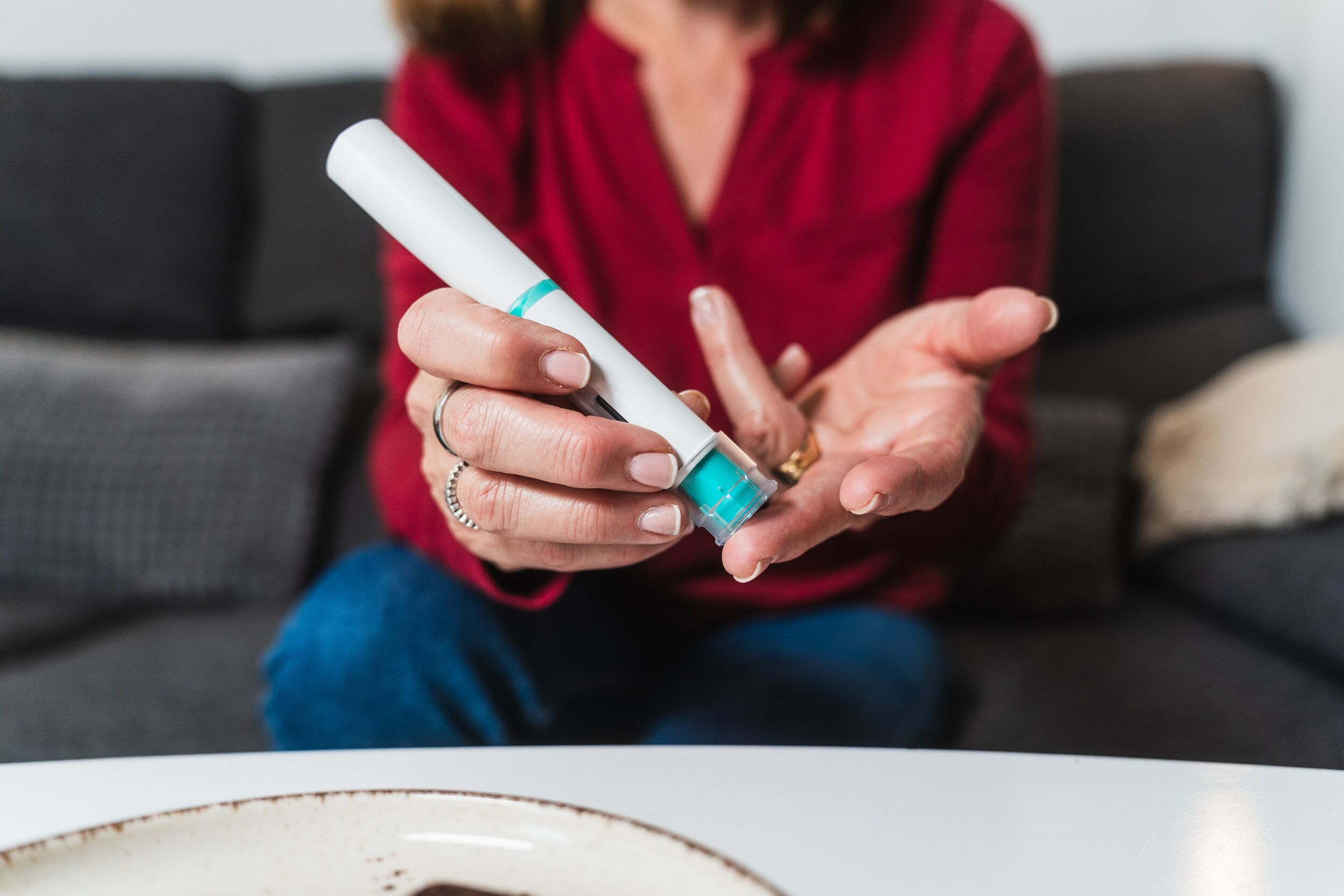 Woman preparing insulin injection for hypoglycemia management.