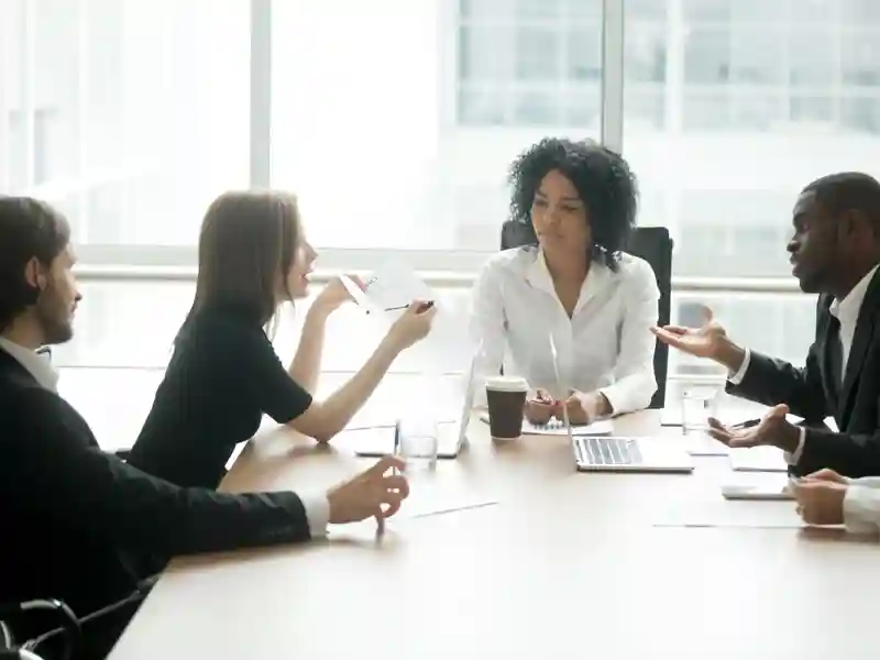 Coworkers have a discussion at a conference table