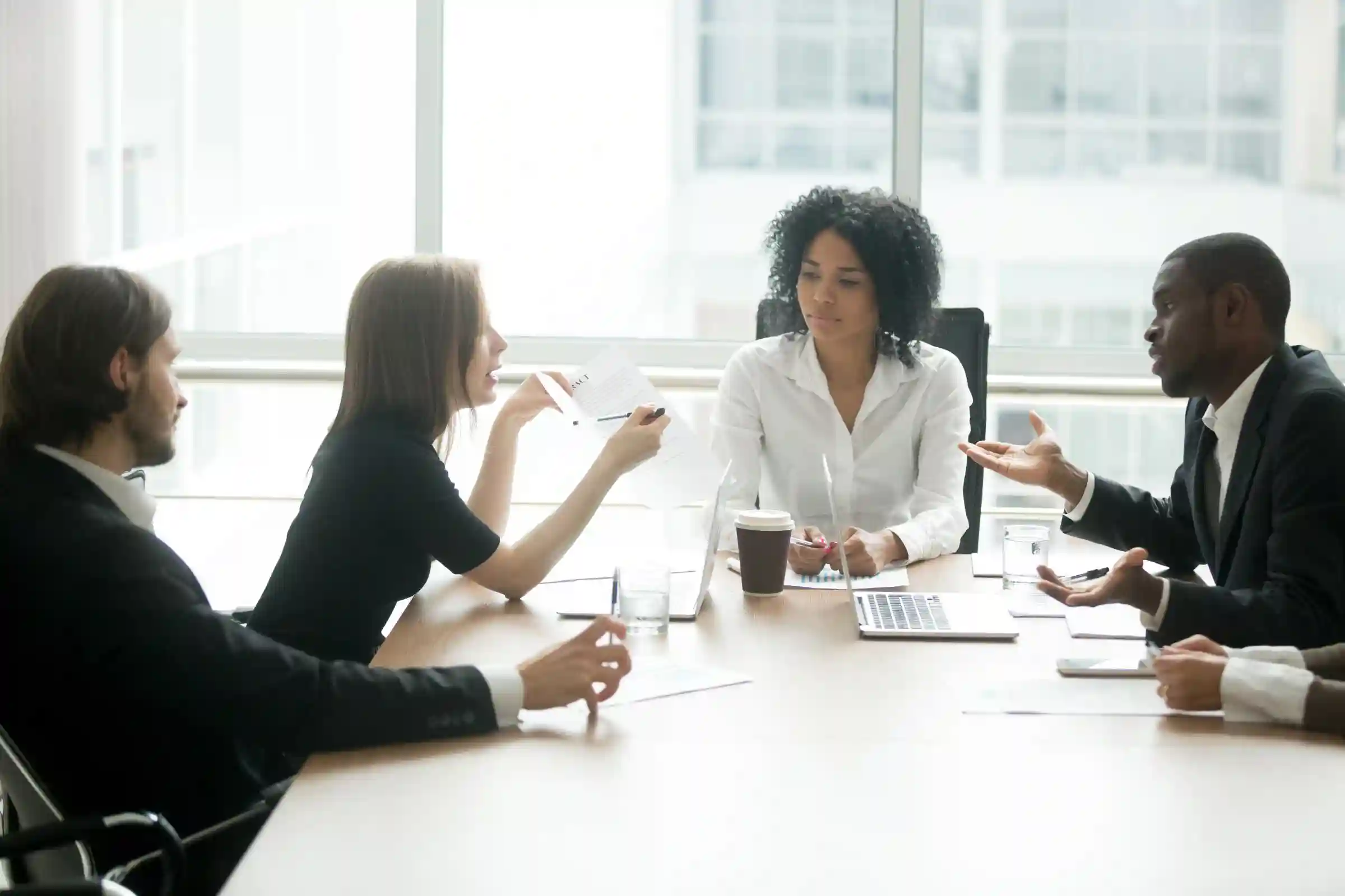Coworkers have a discussion at a conference table