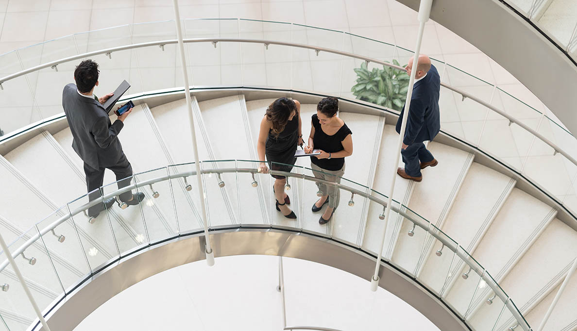 Professionals on a spiral staircase.