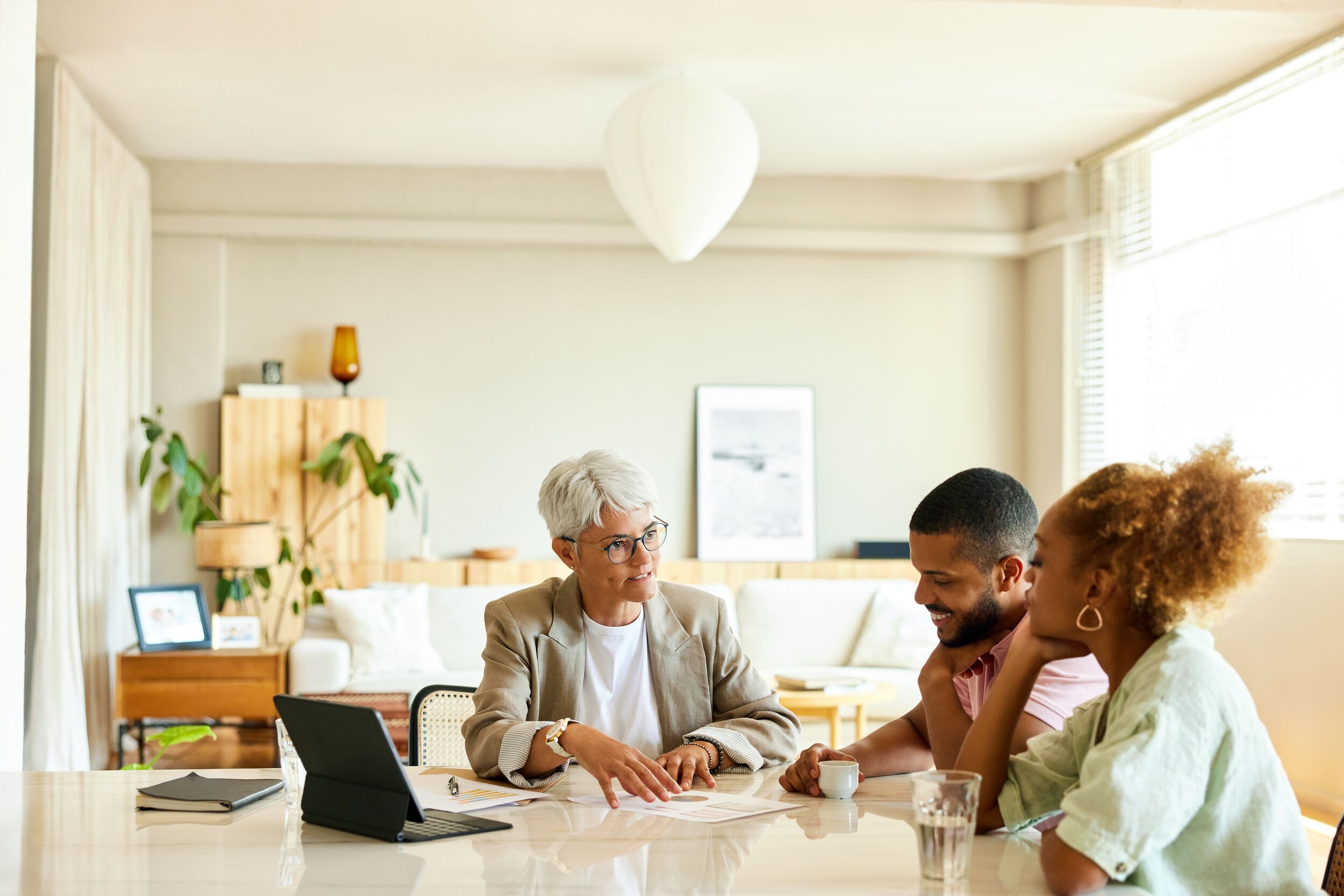 Finance advisor explaining couple at apartment.