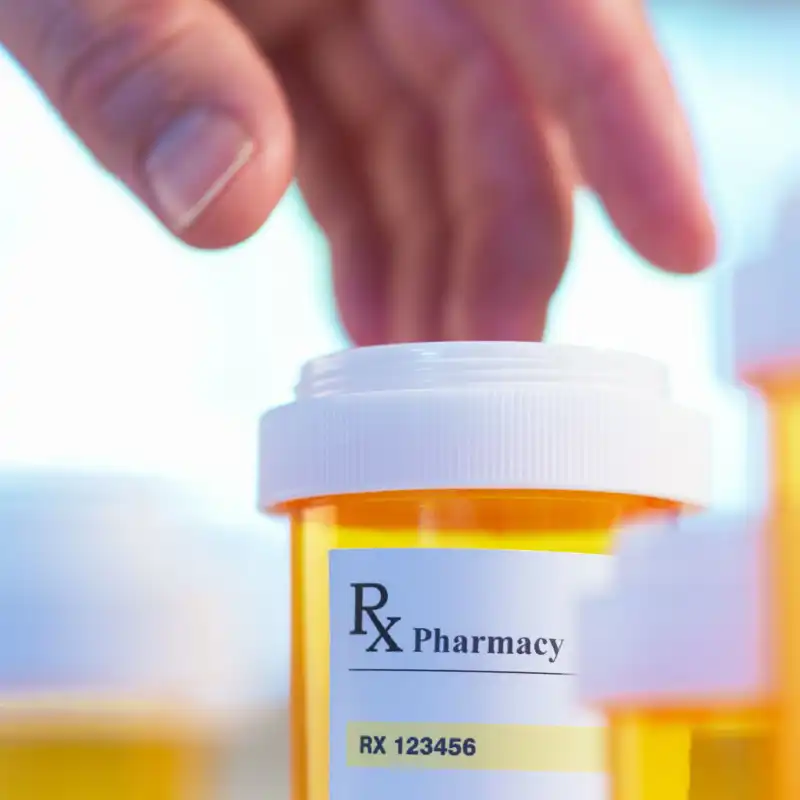 Prescription bottle and hand with motion blur selective focus