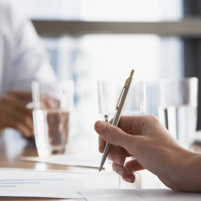 Person holding a silver pen.