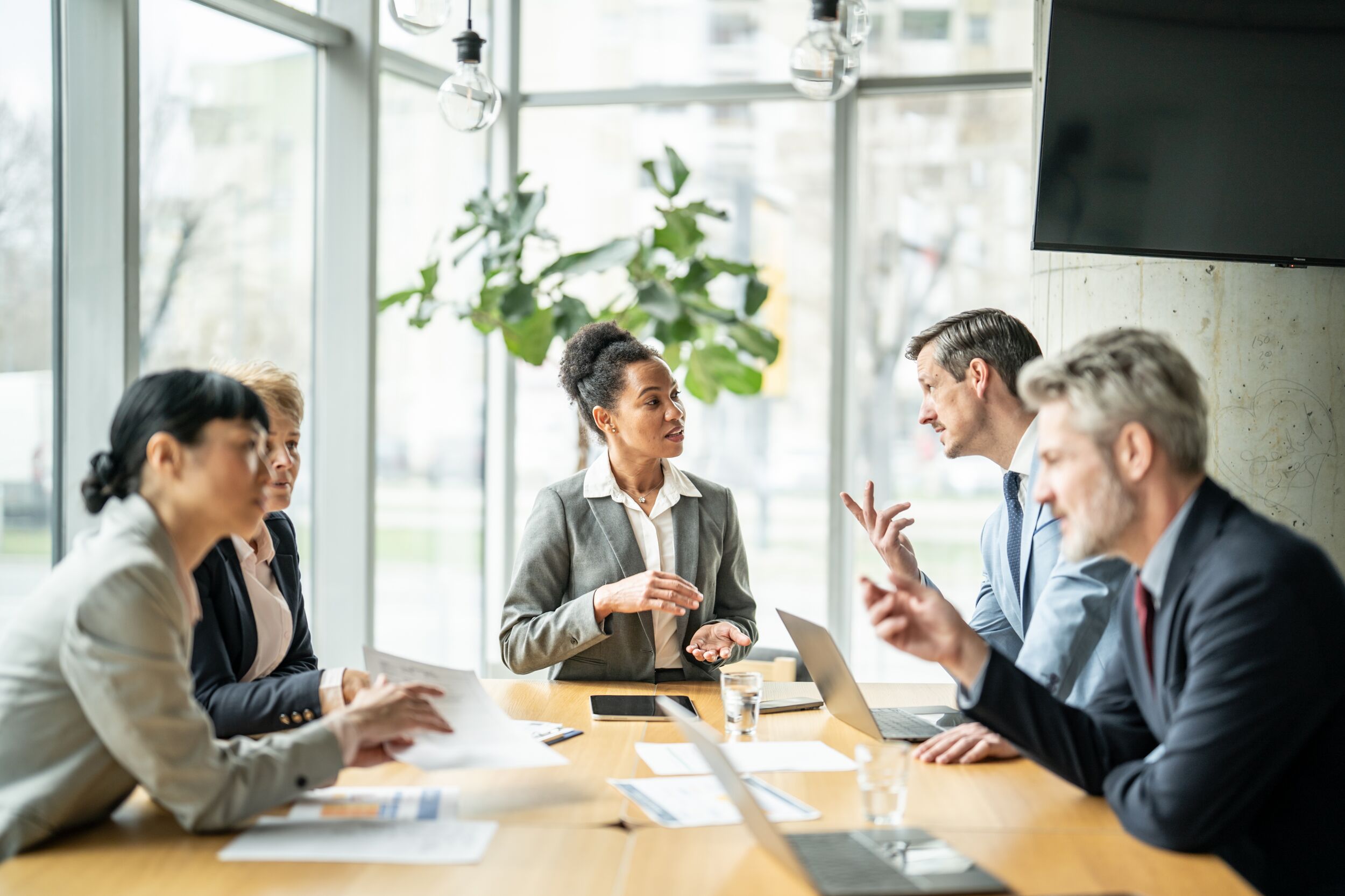 Coworkers talking at a conference table.