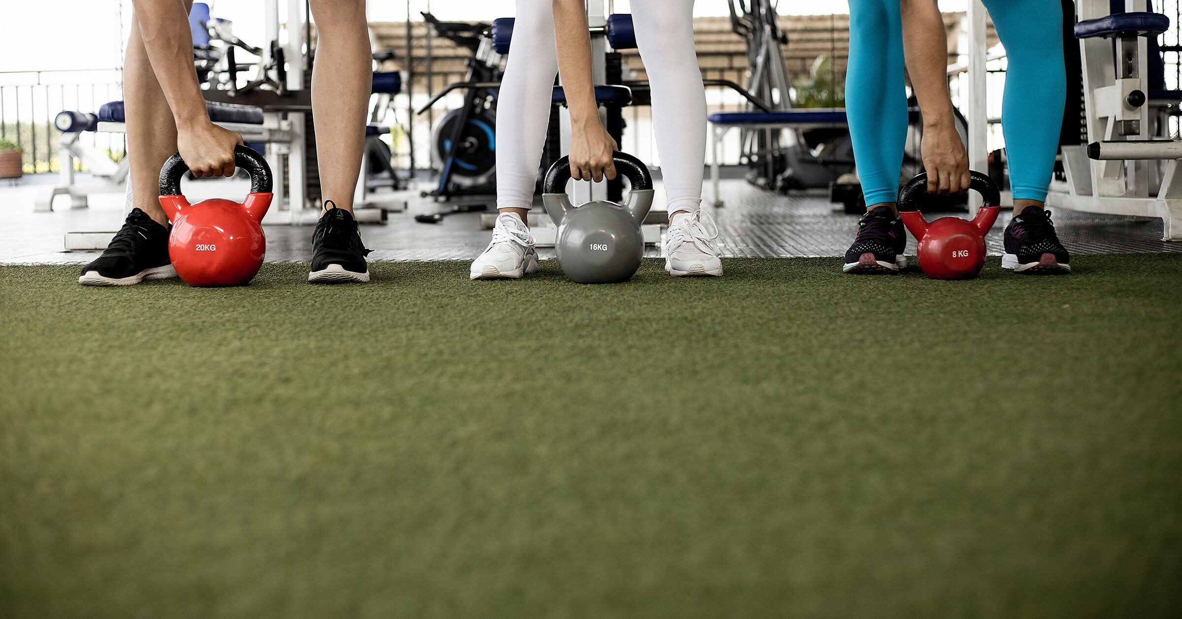 People working out with kettlebell in the gym.