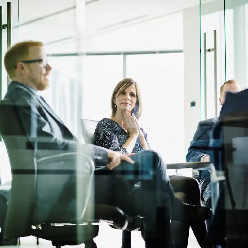 Executives sitting in a modern office having a meeting.