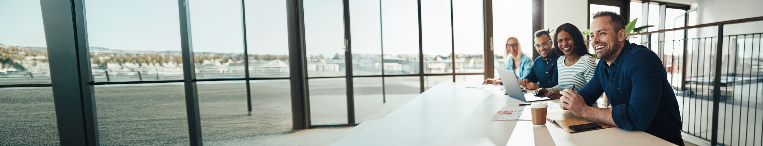 Coworkers smiling during a meeting.