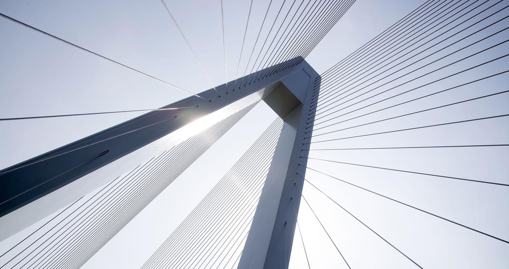 looking up to the top of a bridge from the ground