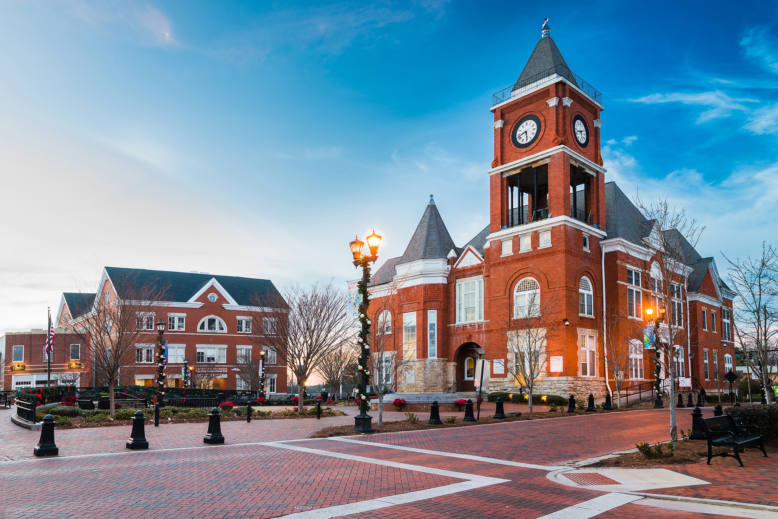Street view of an old government building in a town square.