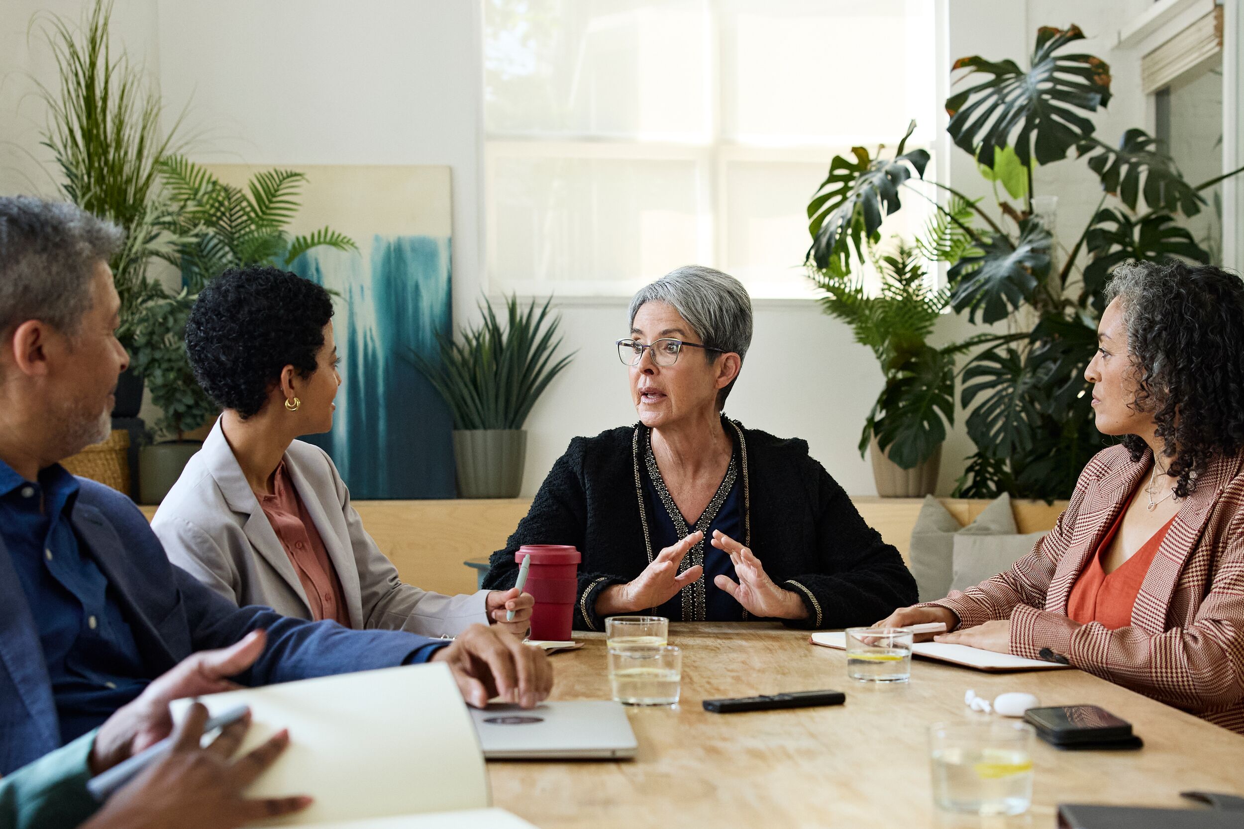 Businesswoman explaining corporate goals to her coworkers.