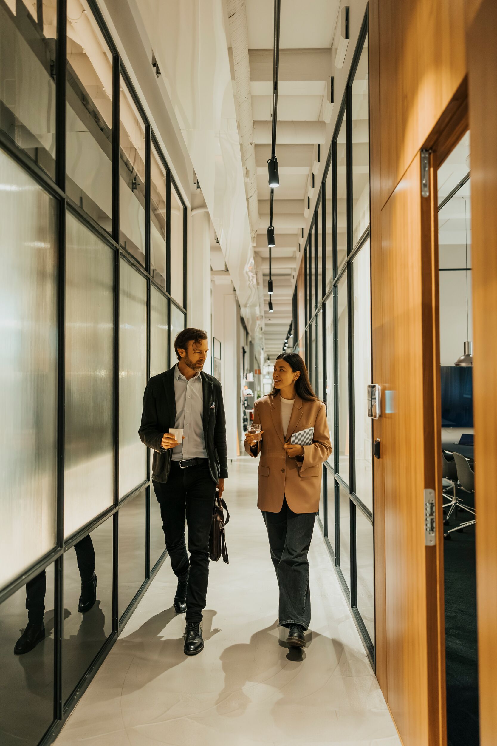 Coworkers walking down an office hallway.