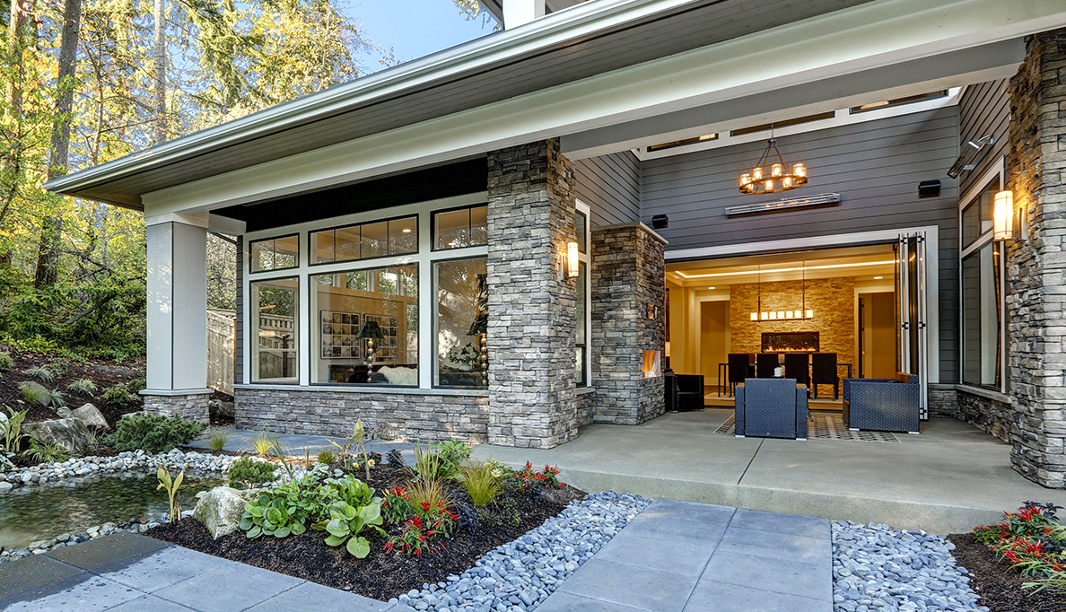 Close up of a well-lit house in the woods.